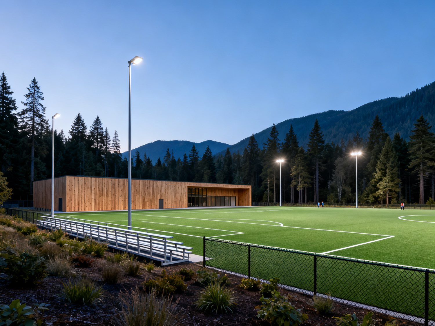 Concept illustration of a floodlit community-scale artificial turf field beside the sports building
